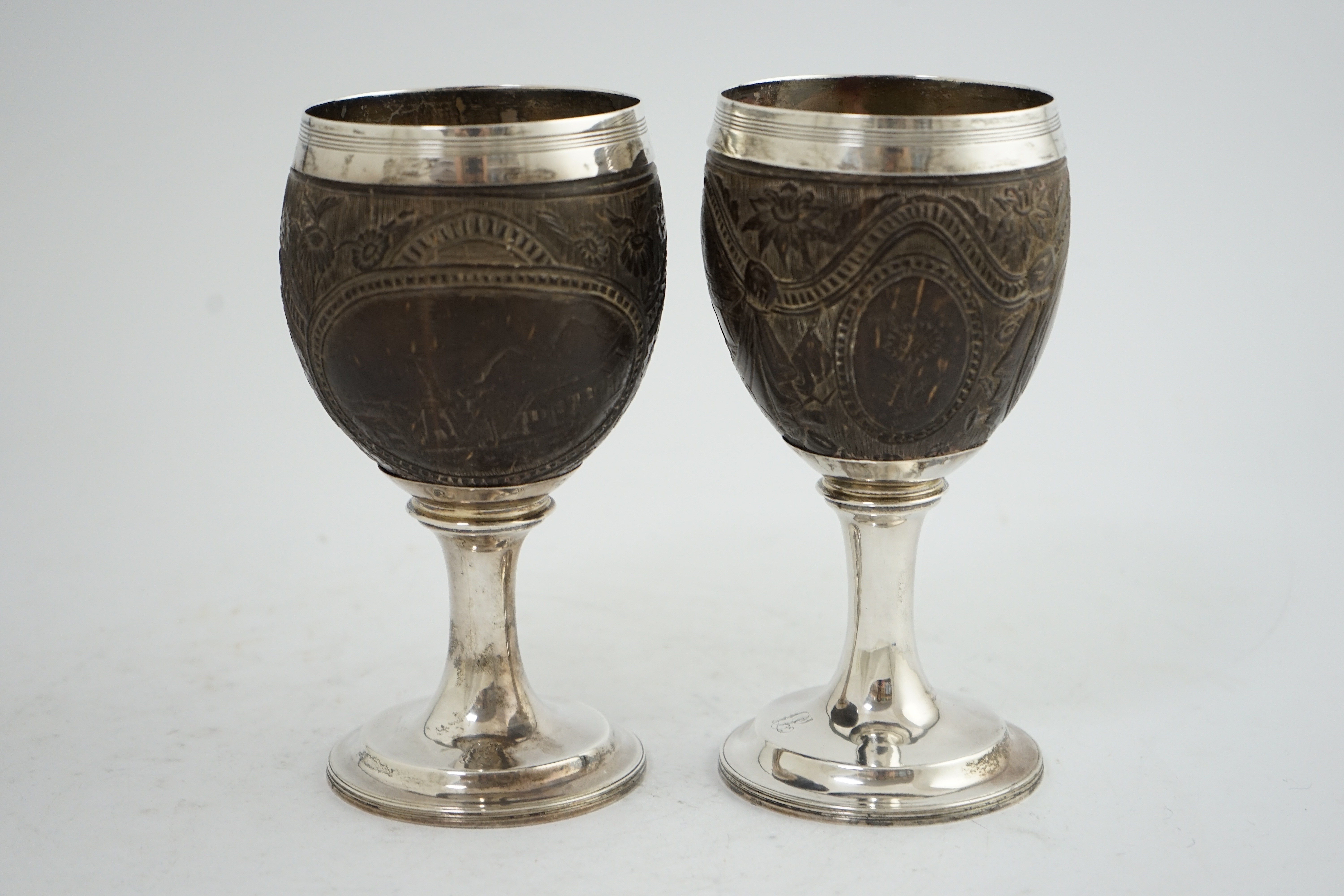 A pair of George III silver mounted coconut cups, maker I.T?